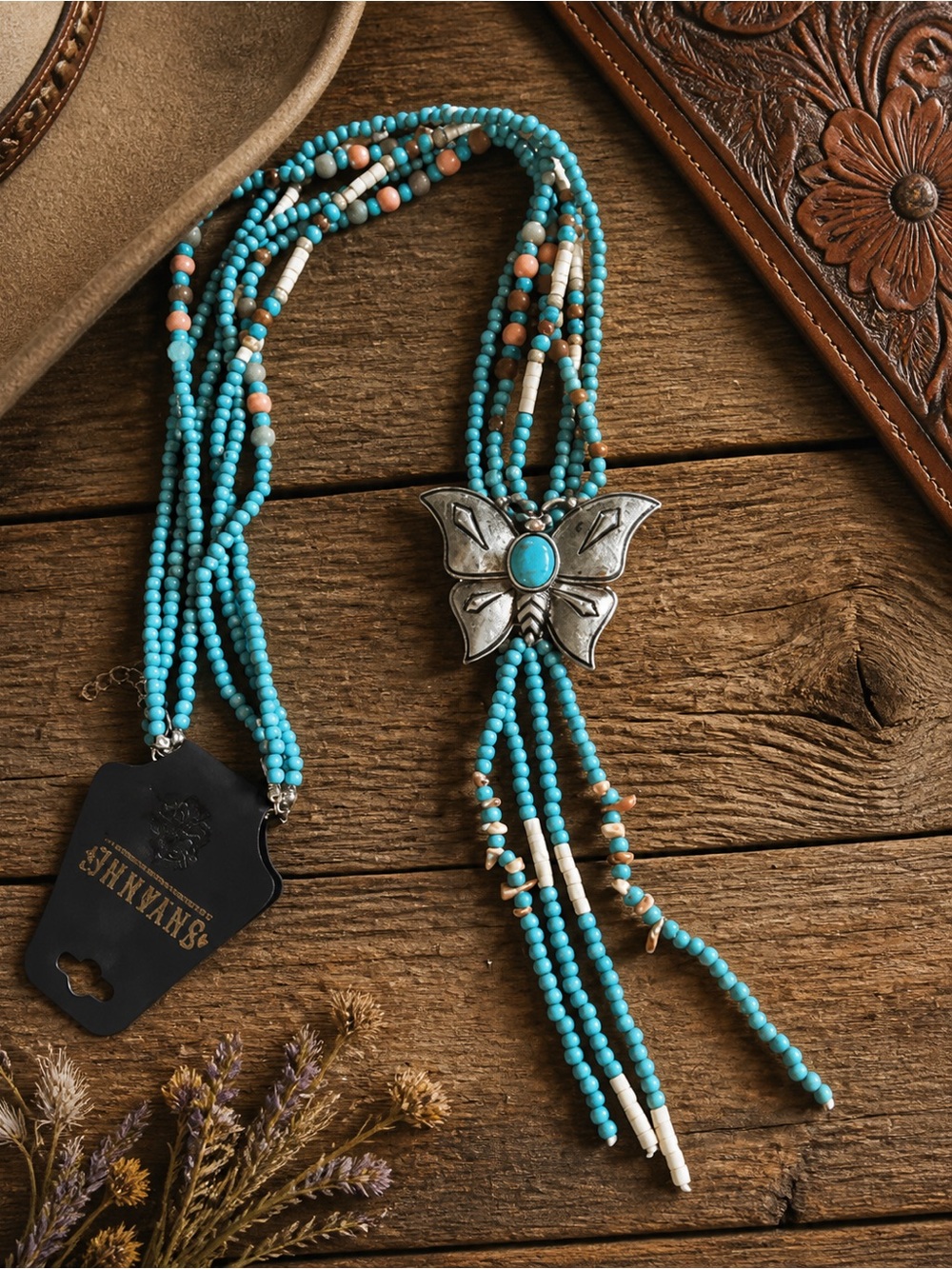 Shyanne woman’s wildflower bloom butterfly bolo necklace.